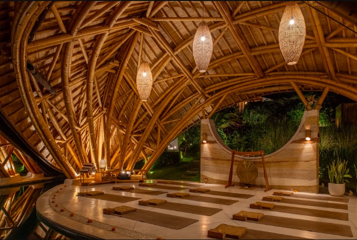 Bamboo yoga and meditation shala at night: the kind of retreat space Zoë Wisdom sessions are held in